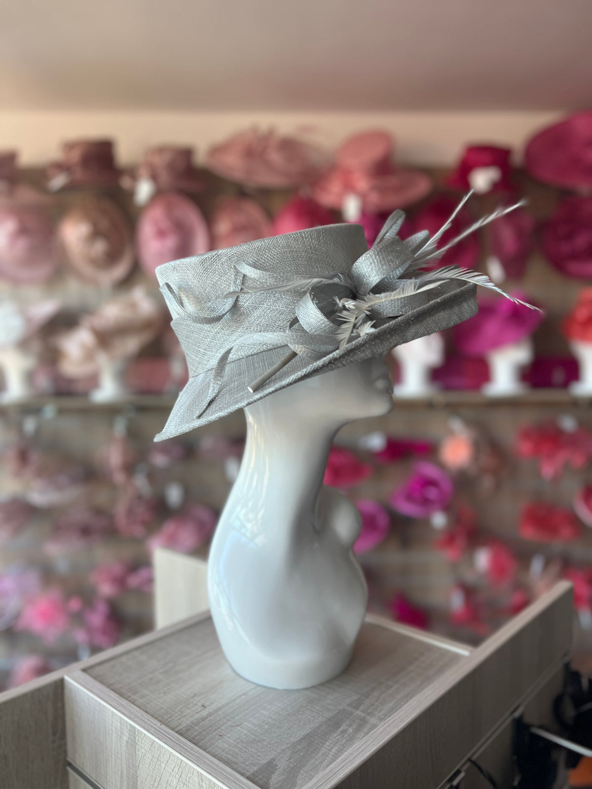 Light grey fascinator with 2024 ruffles and bows