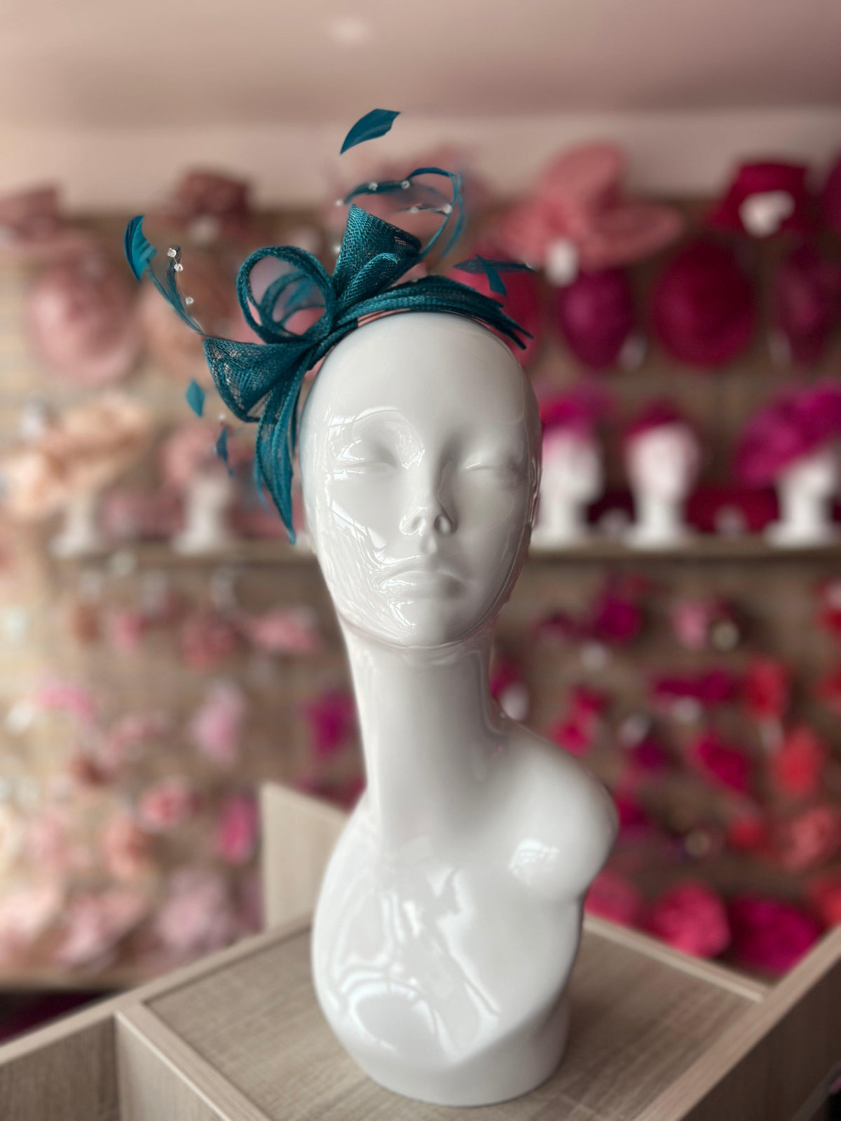 Royal fashion blue fascinator with sinamay loops, cream flower and netting on a headband!