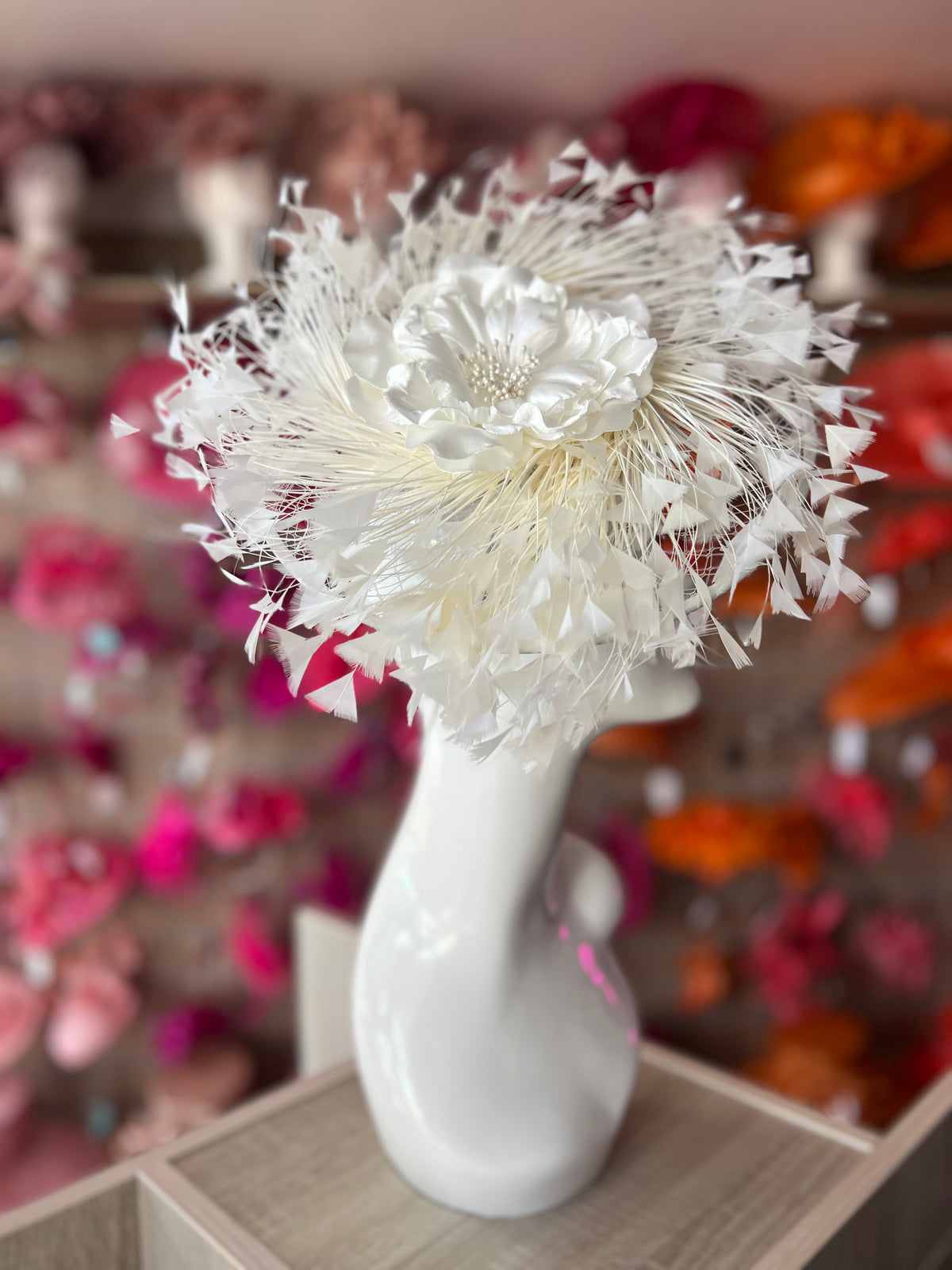 Ivory Saucer Hatinator With Array Of Feathers &amp; Satin Flower